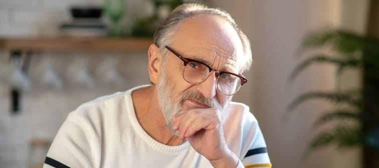Senior man looking at camera with concern